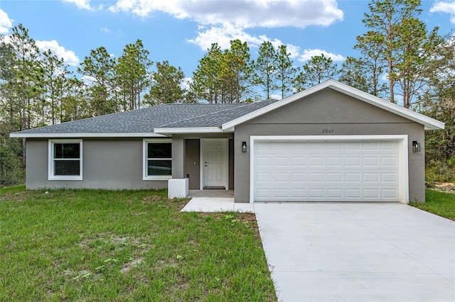 23163 NW Shamrock Ave, Dunnellon, FL 34431 - ranch-style home with a front yard, an attached garage, concrete driveway, a shingled roof, and stucco siding