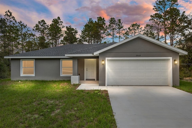 23163 NW Shamrock Ave, Dunnellon, FL 34431 - ranch-style home featuring an attached garage, a shingled roof, driveway, a front lawn, and stucco siding