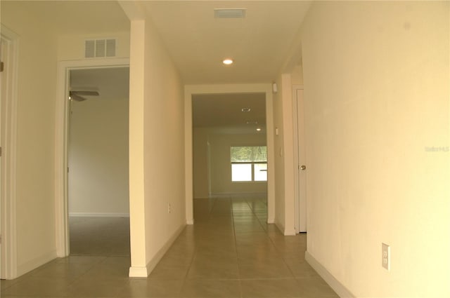hall with light tile patterned flooring, baseboards, and recessed lighting