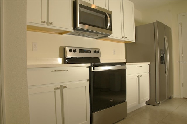 kitchen with stainless steel appliances, light tile patterned floors, white cabinets, and light countertops