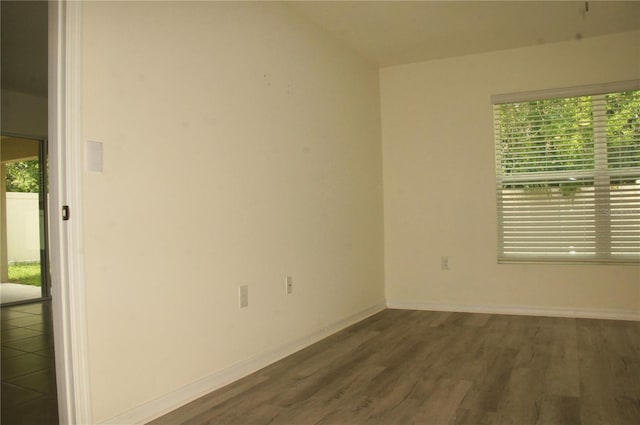 unfurnished room with wood finished floors and baseboards