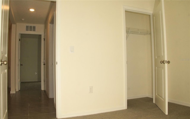 unfurnished bedroom with a closet, baseboards, and recessed lighting