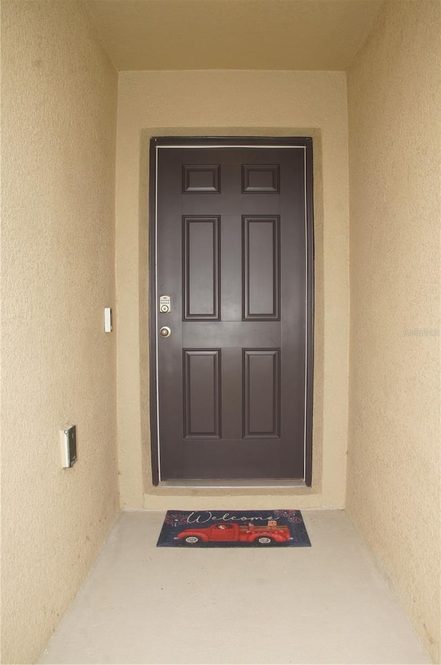 property entrance with stucco siding