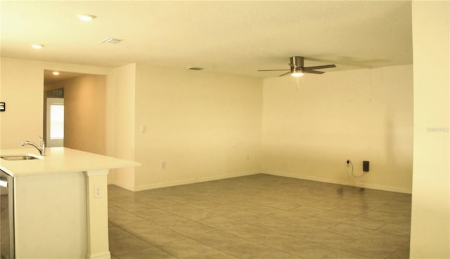 spare room with a sink, light tile patterned floors, ceiling fan, recessed lighting, and baseboards