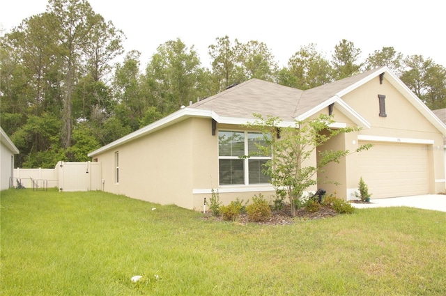 view of front of house with stucco siding, driveway, a garage, and a gate