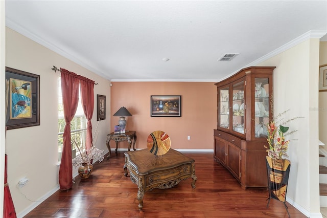 living area with dark wood-style floors, crown molding, and baseboards