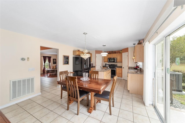 dining space featuring a chandelier and light tile patterned flooring
