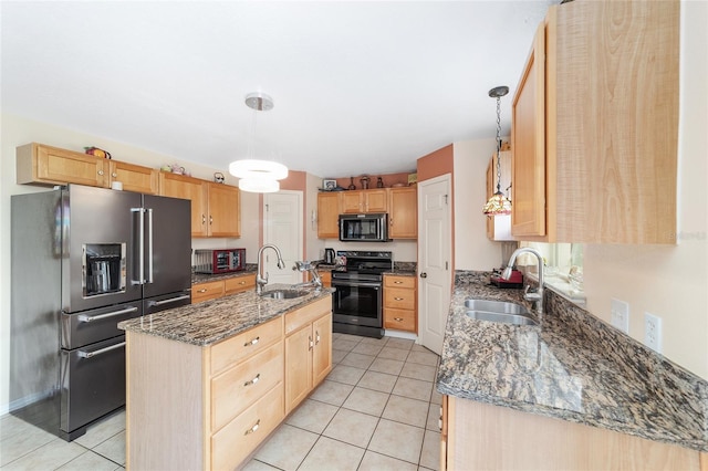 kitchen with stainless steel appliances, a sink, and light brown cabinetry