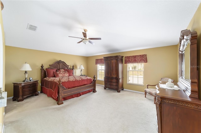bedroom featuring light carpet, baseboards, and a ceiling fan