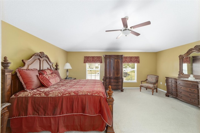 carpeted bedroom featuring baseboards and a ceiling fan