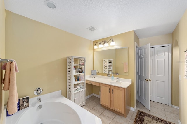 full bath featuring tile patterned flooring, a garden tub, vanity, and baseboards