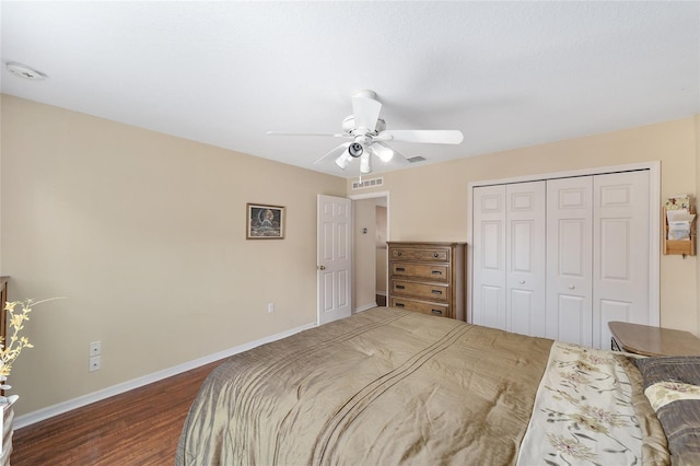 bedroom with dark wood finished floors, baseboards, a closet, and a ceiling fan