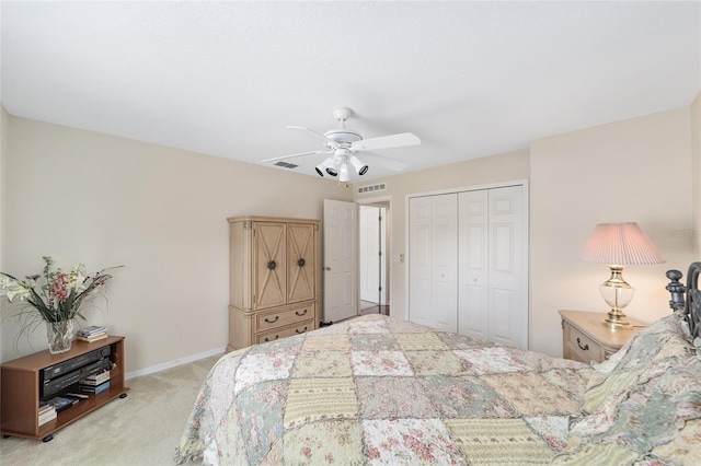 bedroom featuring light colored carpet, a closet, ceiling fan, and baseboards