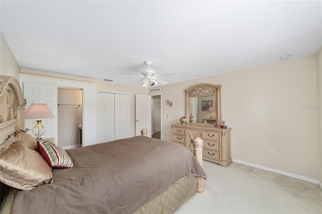 bedroom with baseboards, light colored carpet, a ceiling fan, and a closet