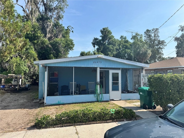 view of front of house with a sunroom
