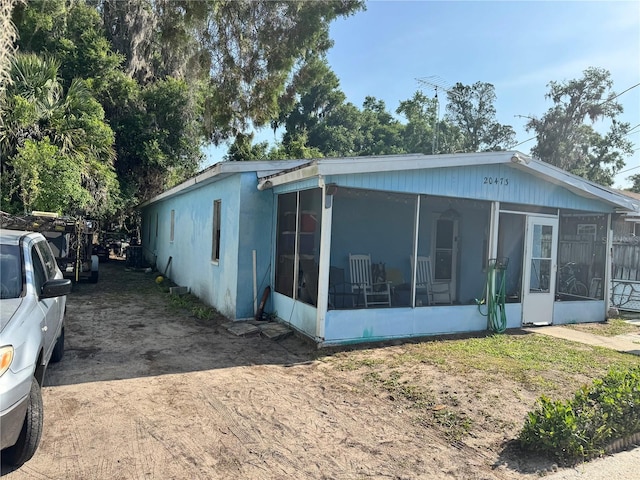 view of side of property with a sunroom
