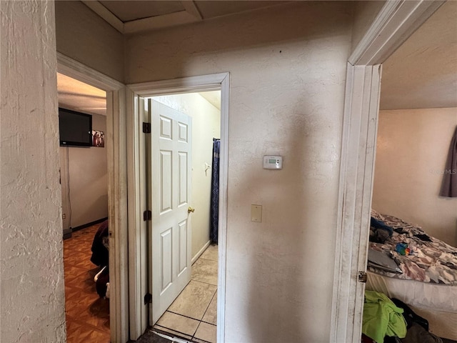 hall with a textured wall