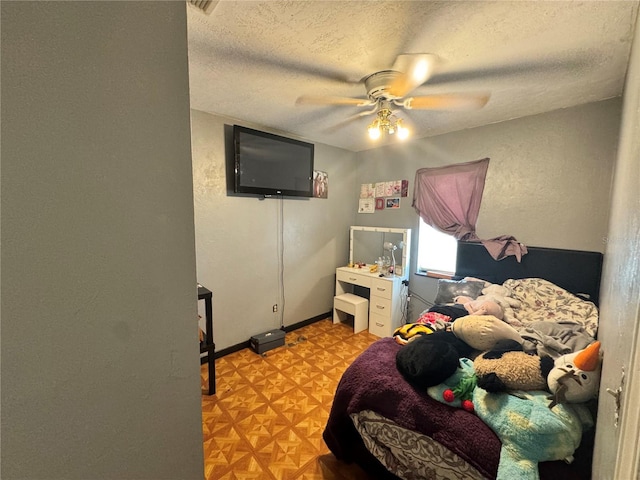 bedroom with a textured ceiling and ceiling fan