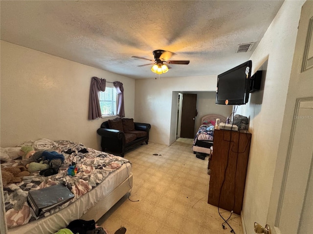 bedroom with light flooring, a textured ceiling, and ceiling fan