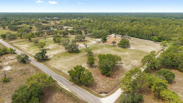 aerial view of property's location featuring a heavily wooded area