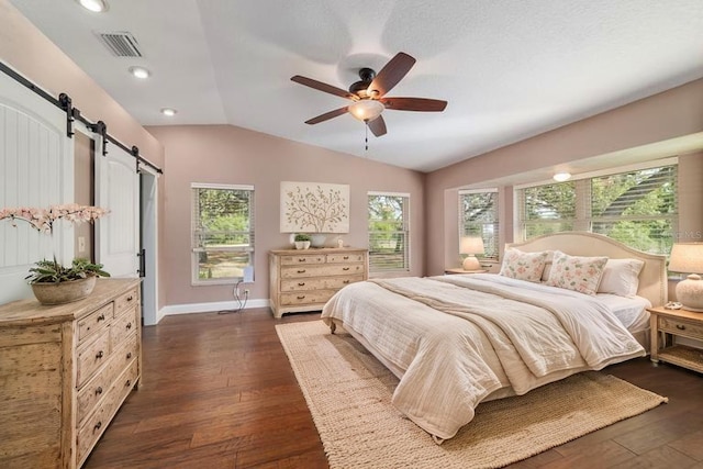 bedroom with a barn door, lofted ceiling, dark wood-style flooring, baseboards, and recessed lighting