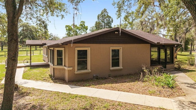 view of home's exterior featuring a lawn and stucco siding