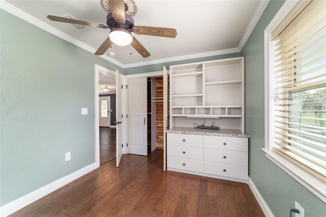 unfurnished bedroom with baseboards, dark wood-style flooring, ornamental molding, a ceiling fan, and a closet