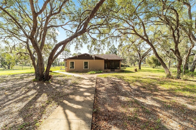 view of side of property with a sunroom and stucco siding