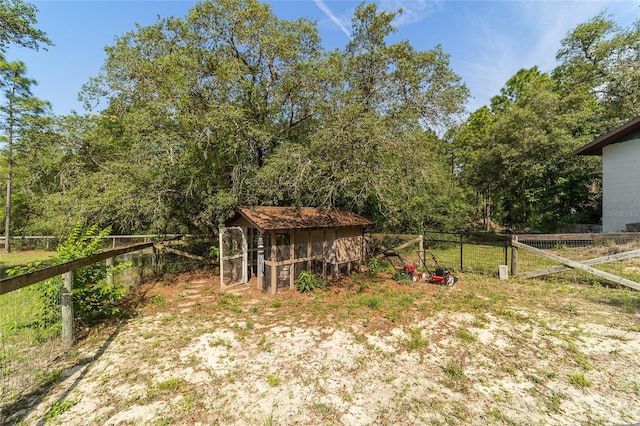 view of yard with exterior structure, fence, and an outbuilding