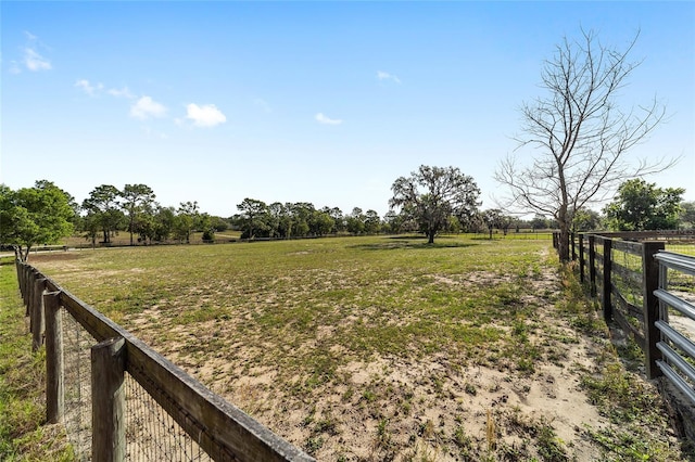 view of yard featuring a rural view and fence