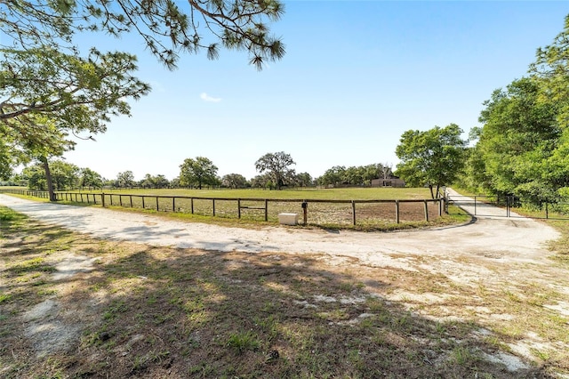 view of yard featuring fence and a view of rural / pastoral area