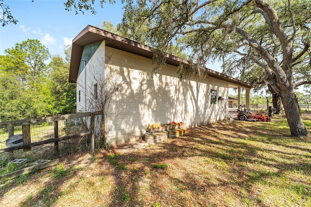view of home's exterior with fence