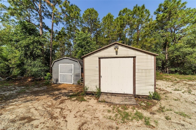 view of shed featuring view of wooded area