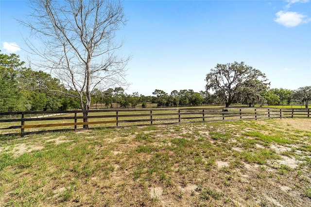 view of yard featuring a view of countryside and fence