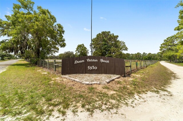 community sign featuring fence