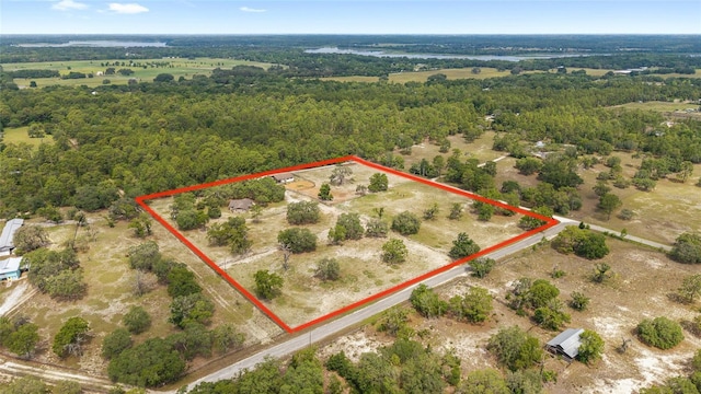 aerial view of property and surrounding area featuring property boundaries highlighted