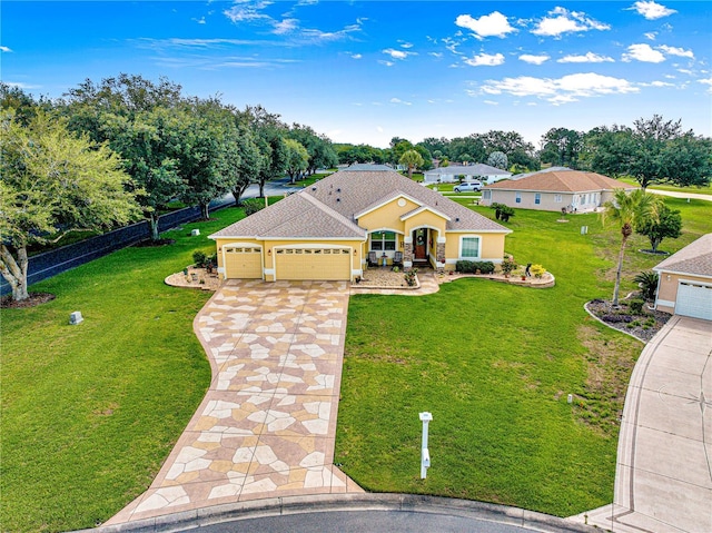 13885 Del Webb Blvd, Summerfield, FL 34491 - view of front facade featuring concrete driveway, an attached garage, stucco siding, and roof with shingles