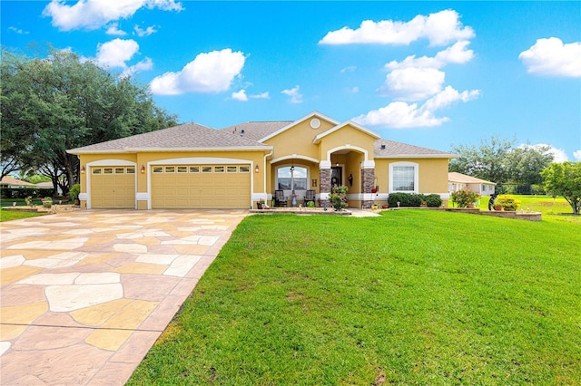 13885 Del Webb Blvd, Summerfield, FL 34491 - view of front facade featuring stucco siding, an attached garage, concrete driveway, and a front lawn