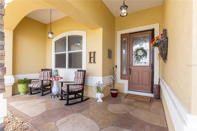 13885 Del Webb Blvd, Summerfield, FL 34491 - view of exterior entry with stucco siding and a porch
