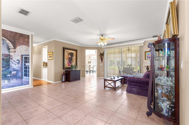 13885 Del Webb Blvd, Summerfield, FL 34491 - living area featuring a ceiling fan, baseboards, crown molding, and light tile patterned floors