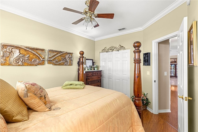 13885 Del Webb Blvd, Summerfield, FL 34491 - bedroom with ornamental molding, wood finished floors, a closet, baseboards, and a ceiling fan