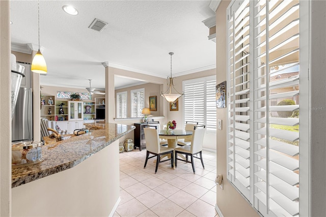 13885 Del Webb Blvd, Summerfield, FL 34491 - dining area featuring ornamental molding, a ceiling fan, light tile patterned flooring, and a textured ceiling