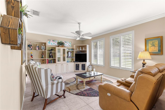 13885 Del Webb Blvd, Summerfield, FL 34491 - living area featuring tile patterned floors, ceiling fan, crown molding, and baseboards
