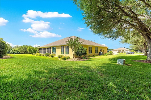 13885 Del Webb Blvd, Summerfield, FL 34491 - rear view of property with a lawn and stucco siding