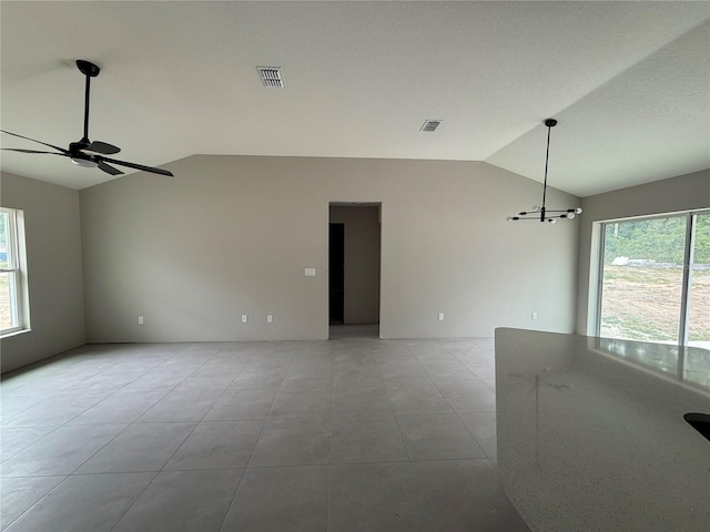 5359 NW 55th Pl, Ocala, FL 34482 - tiled spare room featuring lofted ceiling, a ceiling fan, and a chandelier