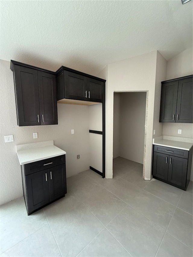 5359 NW 55th Pl, Ocala, FL 34482 - kitchen with light tile patterned flooring, light countertops, and a textured ceiling