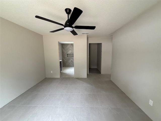 5359 NW 55th Pl, Ocala, FL 34482 - empty room featuring light tile patterned floors, a textured ceiling, and a ceiling fan