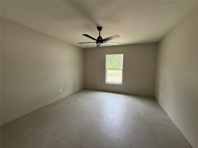5359 NW 55th Pl, Ocala, FL 34482 - empty room featuring ceiling fan, light tile patterned floors, a textured wall, and a textured ceiling