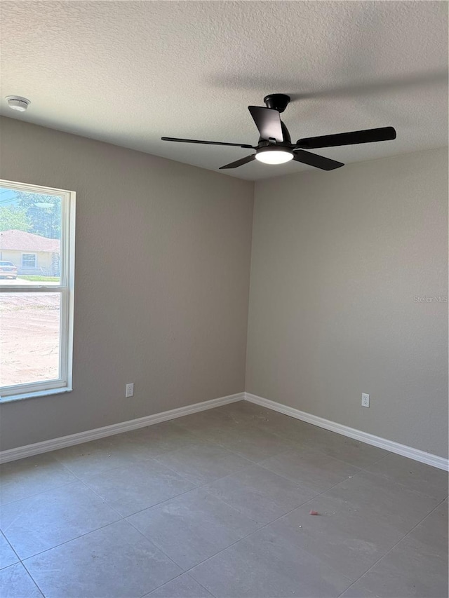 5359 NW 55th Pl, Ocala, FL 34482 - unfurnished room featuring ceiling fan, a textured ceiling, tile patterned floors, and baseboards