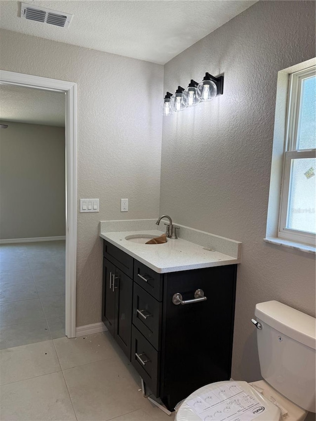 5359 NW 55th Pl, Ocala, FL 34482 - bathroom featuring vanity, toilet, tile patterned floors, and baseboards